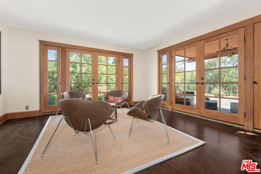33208 Decker School Road Malibu, CA 90265 - Photo 8 of 51 a living room with furniture and floor to ceiling windows