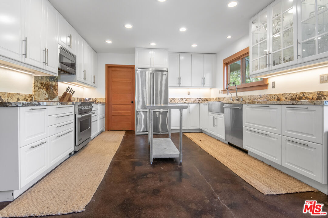 33208 Decker School Road Malibu, CA 90265 - Photo 10 of 51 a kitchen with stainless steel appliances granite countertop lots of counter top space and cabinets