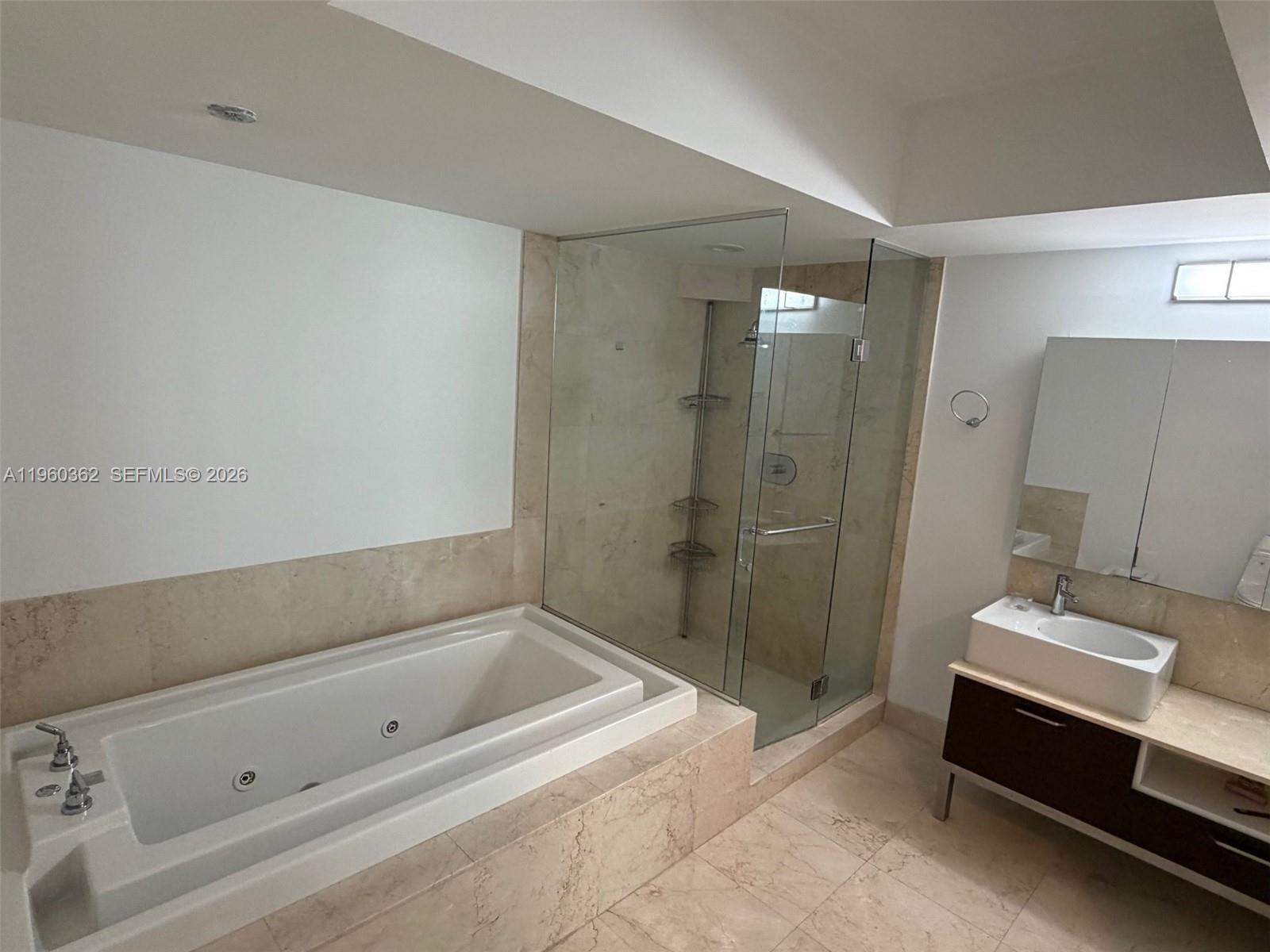 218 Southeast 14th Street, Unit 1406 Miami, FL 33131 - Photo 4 of 8 a bathroom with a tub and a sink