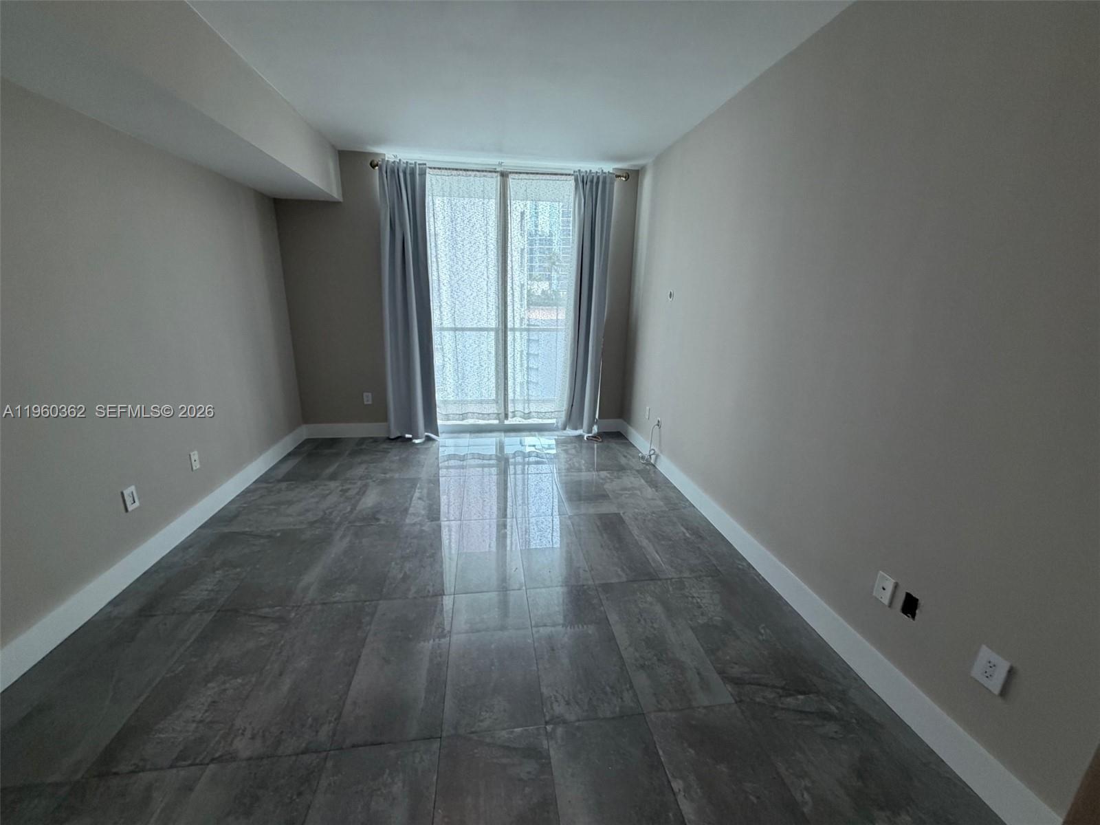 218 Southeast 14th Street, Unit 1406 Miami, FL 33131 - Photo 5 of 8 an empty room with an entryway and window