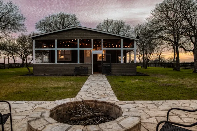 a backyard of a house with lots of green space and lake view