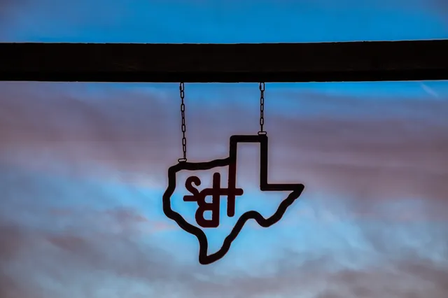a kitchen with stainless steel appliances granite countertop a white cabinets and wooden floor