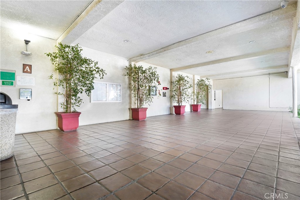 5460 White Oak Avenue, Unit G213 Encino, CA 91316 - Photo 16 of 22 a view of an empty room with a potted plant