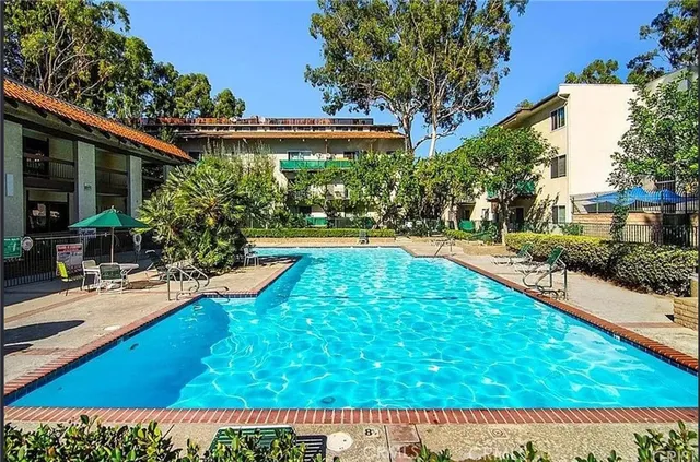 a view of swimming pool with outdoor seating and a garden