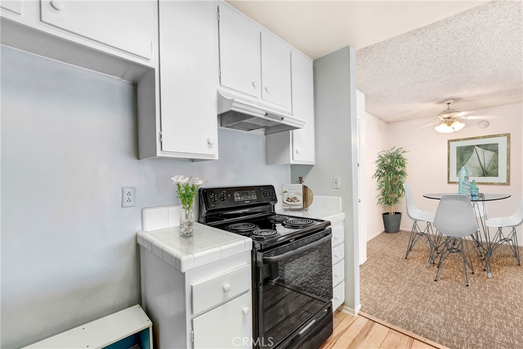 5460 White Oak Avenue, Unit G213 Encino, CA 91316 - Photo 7 of 22 a kitchen with stainless steel appliances granite countertop a stove and a white cabinets