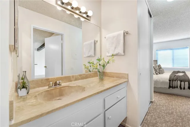 a bathroom with a granite countertop sink a mirror and a