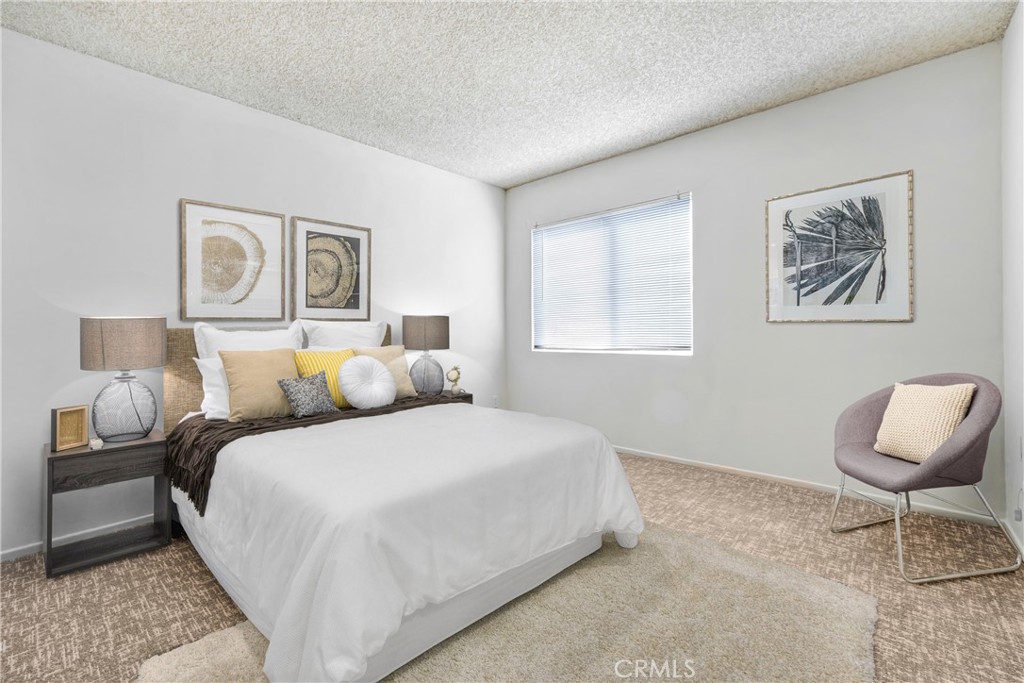 5460 White Oak Avenue, Unit G213 Encino, CA 91316 - Photo 10 of 22 a bedroom with a bed and a lamp