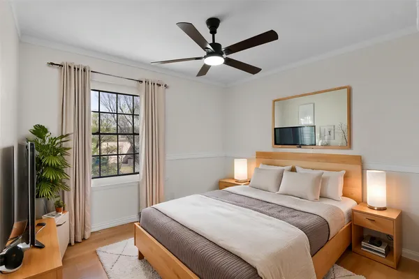 a bedroom with a bed and a large window