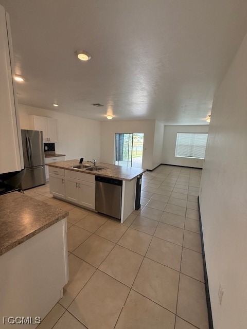 8046 Gopher Tortoise Trail Lehigh Acres, FL 33972 - Photo 3 of 18 a large kitchen with a stove a sink a microwave and cabinets