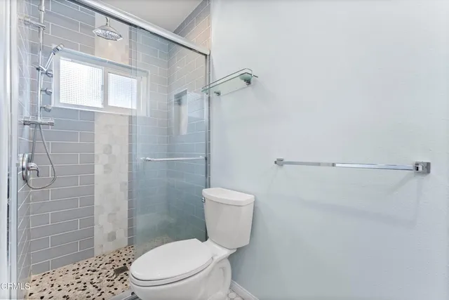 a white toilet sitting next to a bathroom