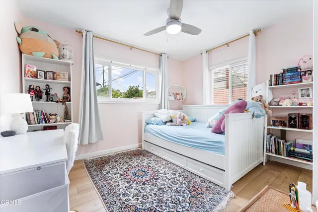 a bedroom with furniture and a rug