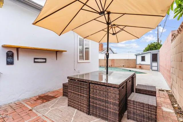 a house view with a backyard and balcony