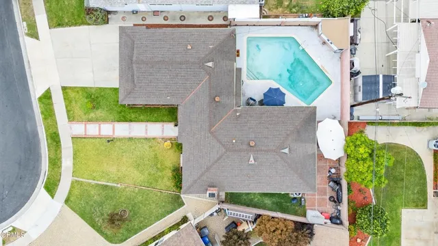 an aerial view of a house with a swimming pool