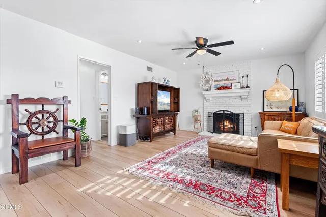 a living room with furniture a fireplace and a flat screen tv