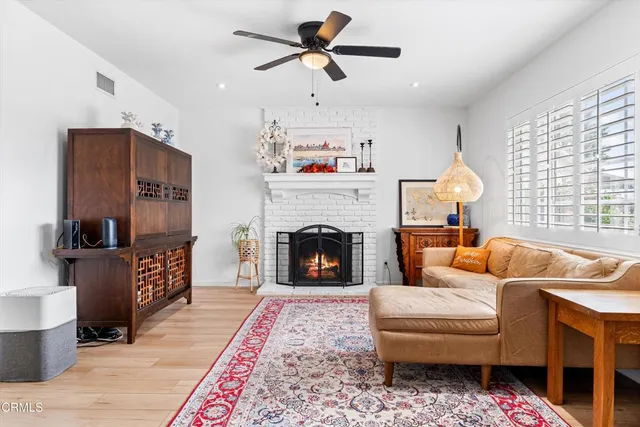 a living room with furniture fireplace and window