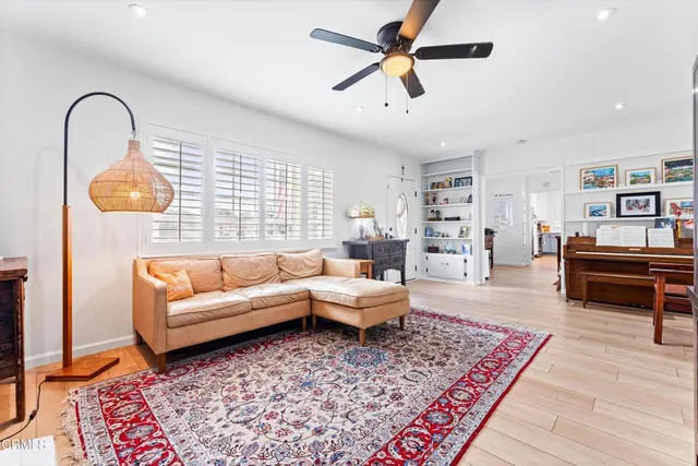 a living room with furniture and wooden floor