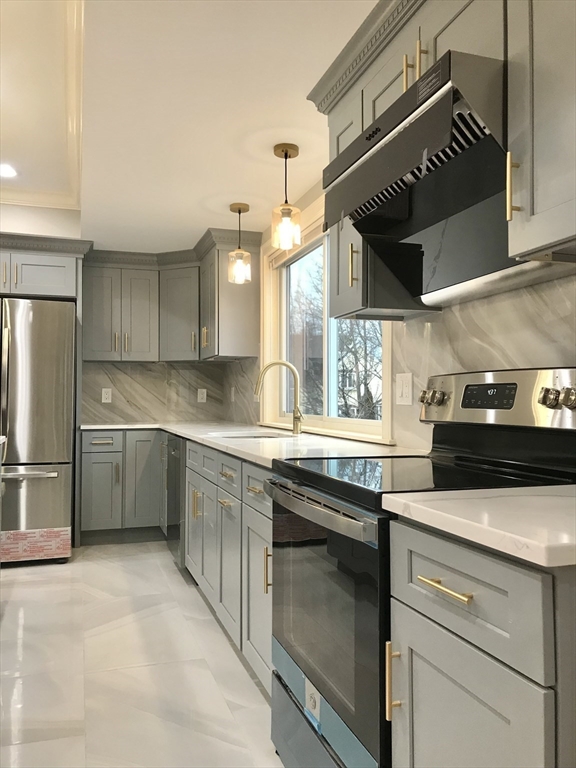 16 Grove Street, Unit 3 Malden, MA 02148 - Photo 2 of 6 a kitchen with a sink cabinets and stainless steel appliances