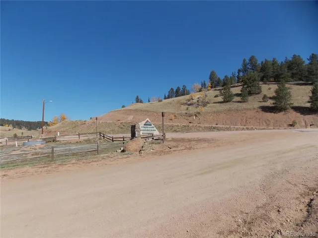 a view of a patio with a table and chairs under an umbrella