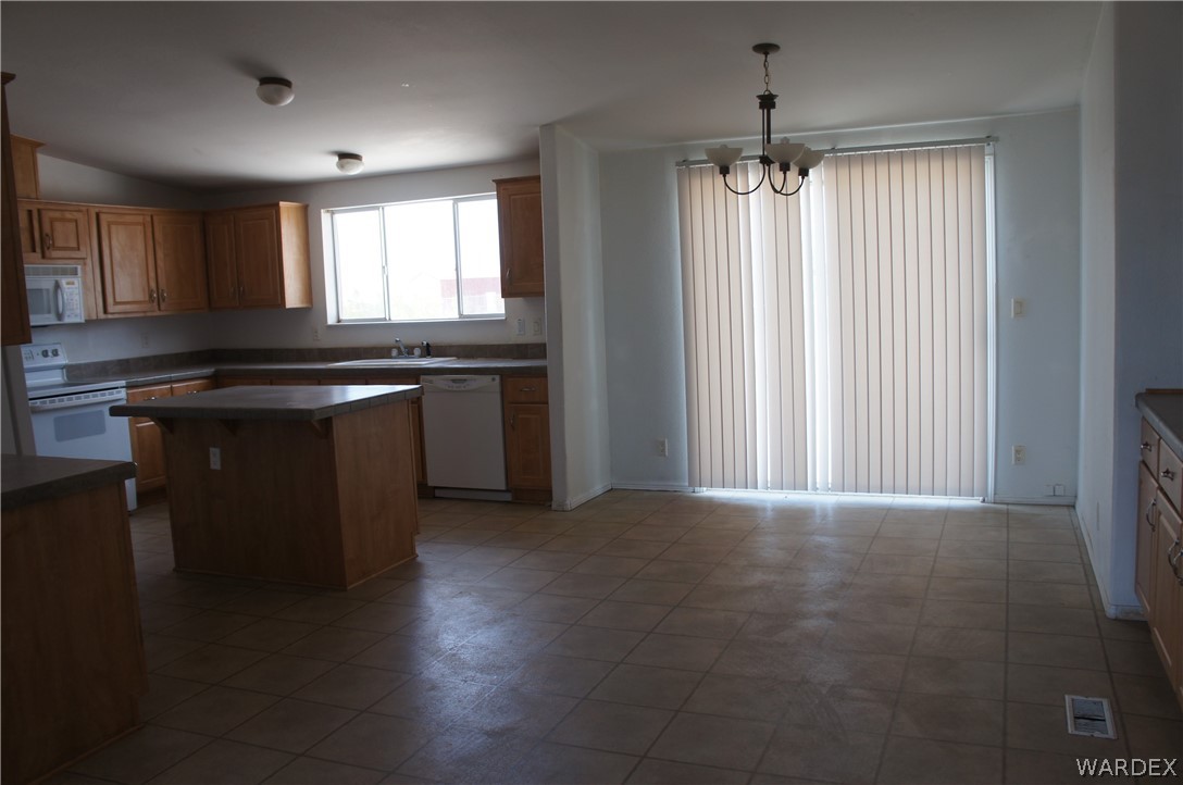 3233 West Rancho Road Golden Valley, AZ 86413 - Photo 13 of 33 a kitchen with kitchen island granite countertop stainless steel appliances a counter top space