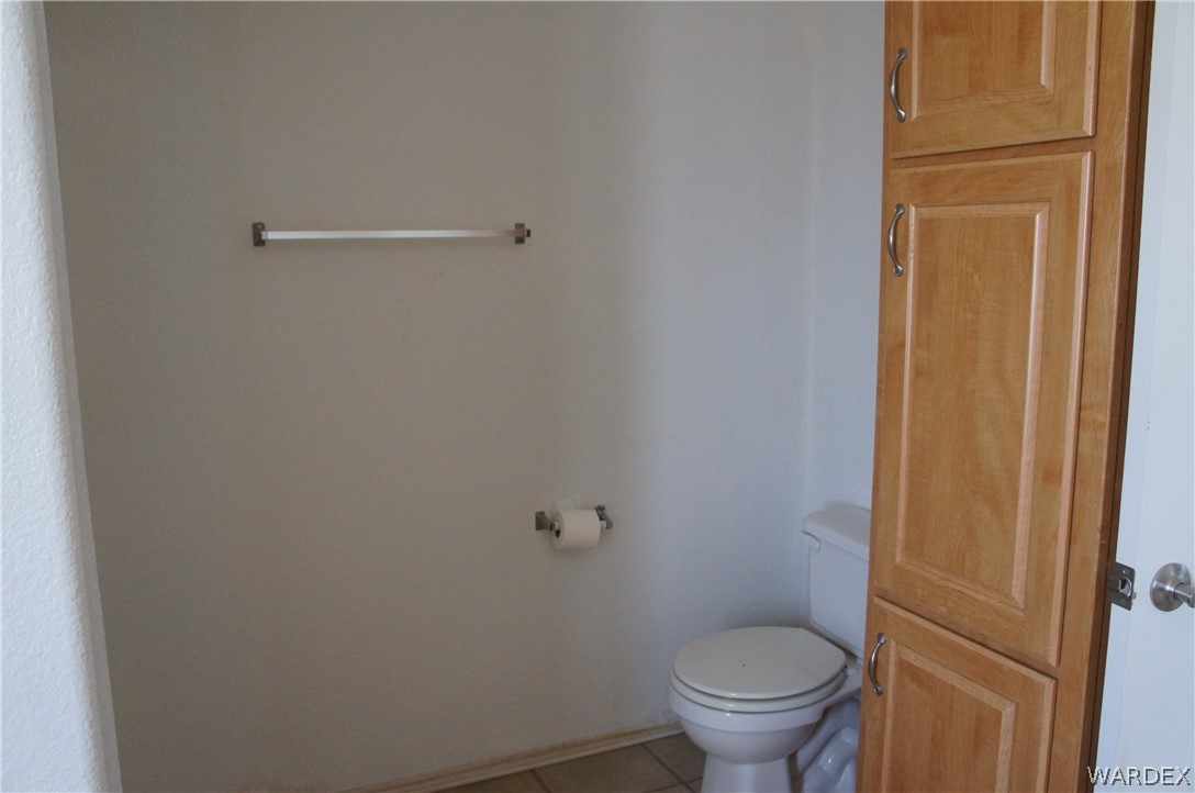 3233 West Rancho Road Golden Valley, AZ 86413 - Photo 19 of 33 a white toilet sitting in a bathroom next to a sink