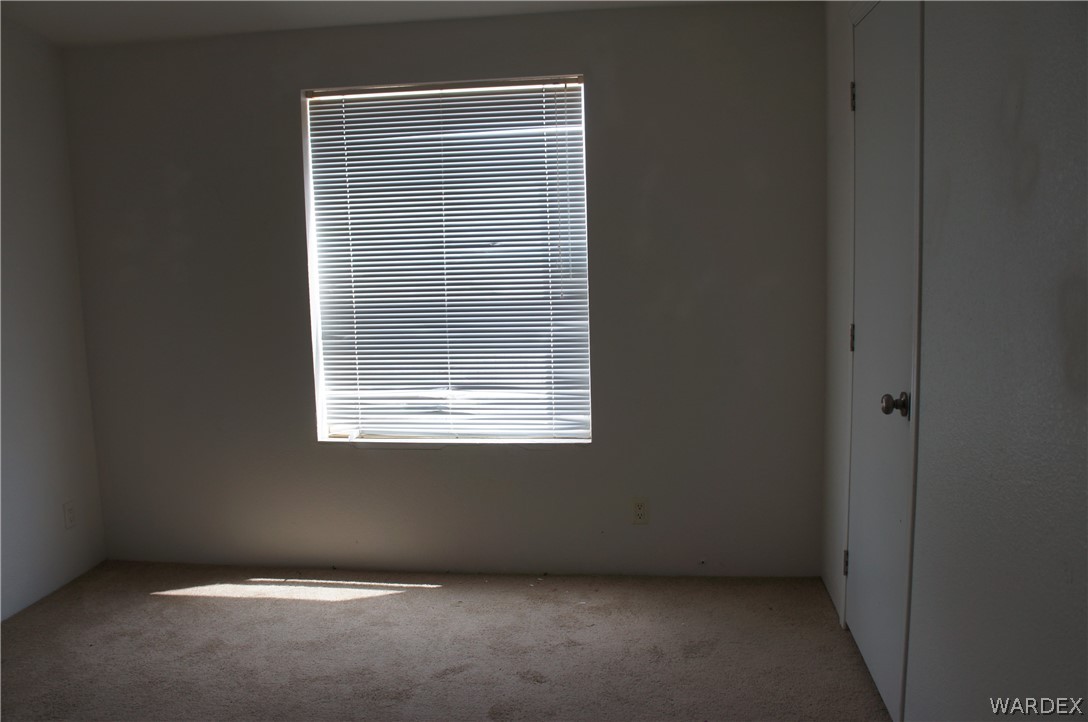 3233 West Rancho Road Golden Valley, AZ 86413 - Photo 23 of 33 a view of an empty room with a window