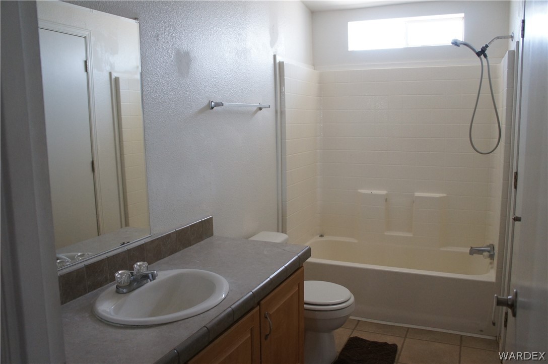 3233 West Rancho Road Golden Valley, AZ 86413 - Photo 24 of 33 a bathroom with a sink toilet and shower