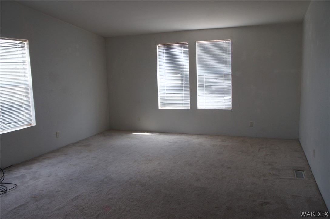 3233 West Rancho Road Golden Valley, AZ 86413 - Photo 27 of 33 an empty room with a window