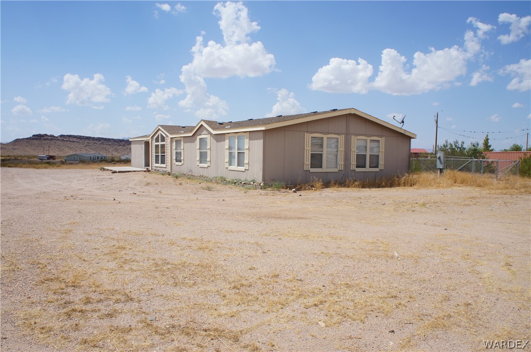 3233 West Rancho Road Golden Valley, AZ 86413 - Photo 4 of 33 a view of a house with a yard