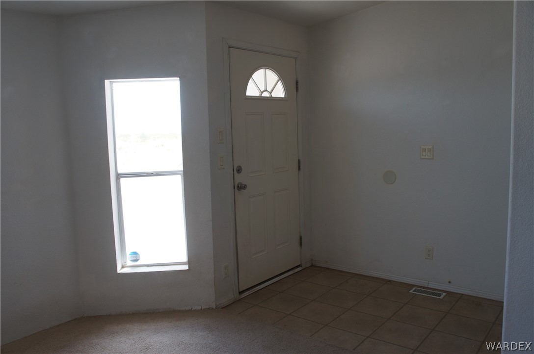 3233 West Rancho Road Golden Valley, AZ 86413 - Photo 10 of 33 an empty room with a window