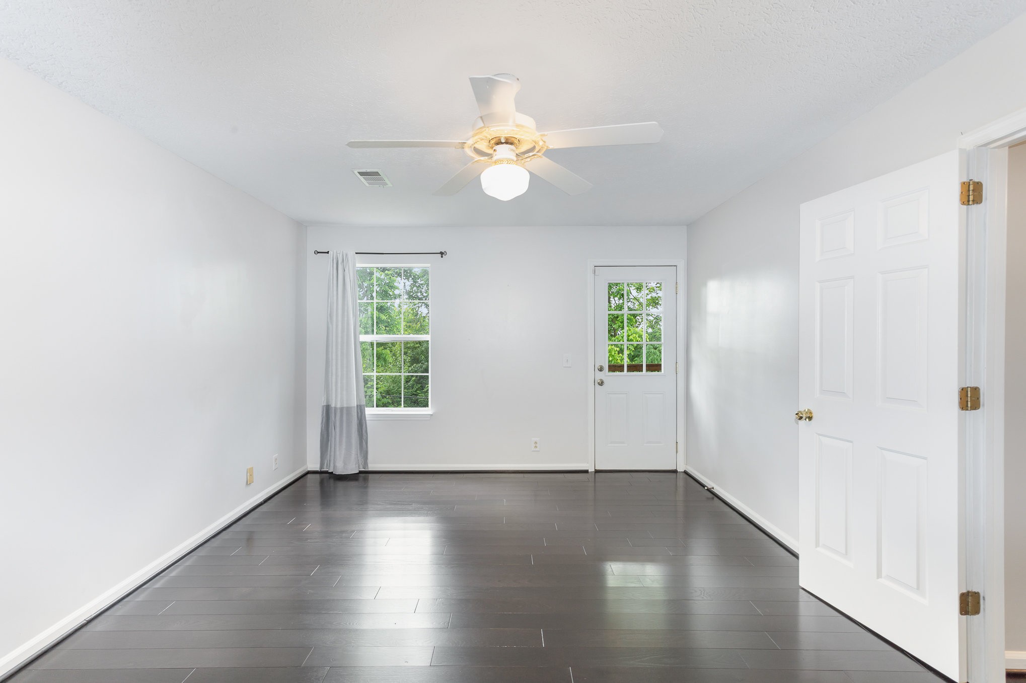 5336 Old Village Road Nashville, TN 37211 - Photo 15 of 25 an empty room with wooden floor chandelier fan and windows