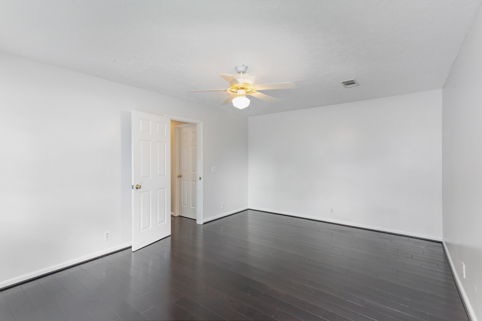 5336 Old Village Road Nashville, TN 37211 - Photo 16 of 25 a view of an empty room with wooden floor and a ceiling fan