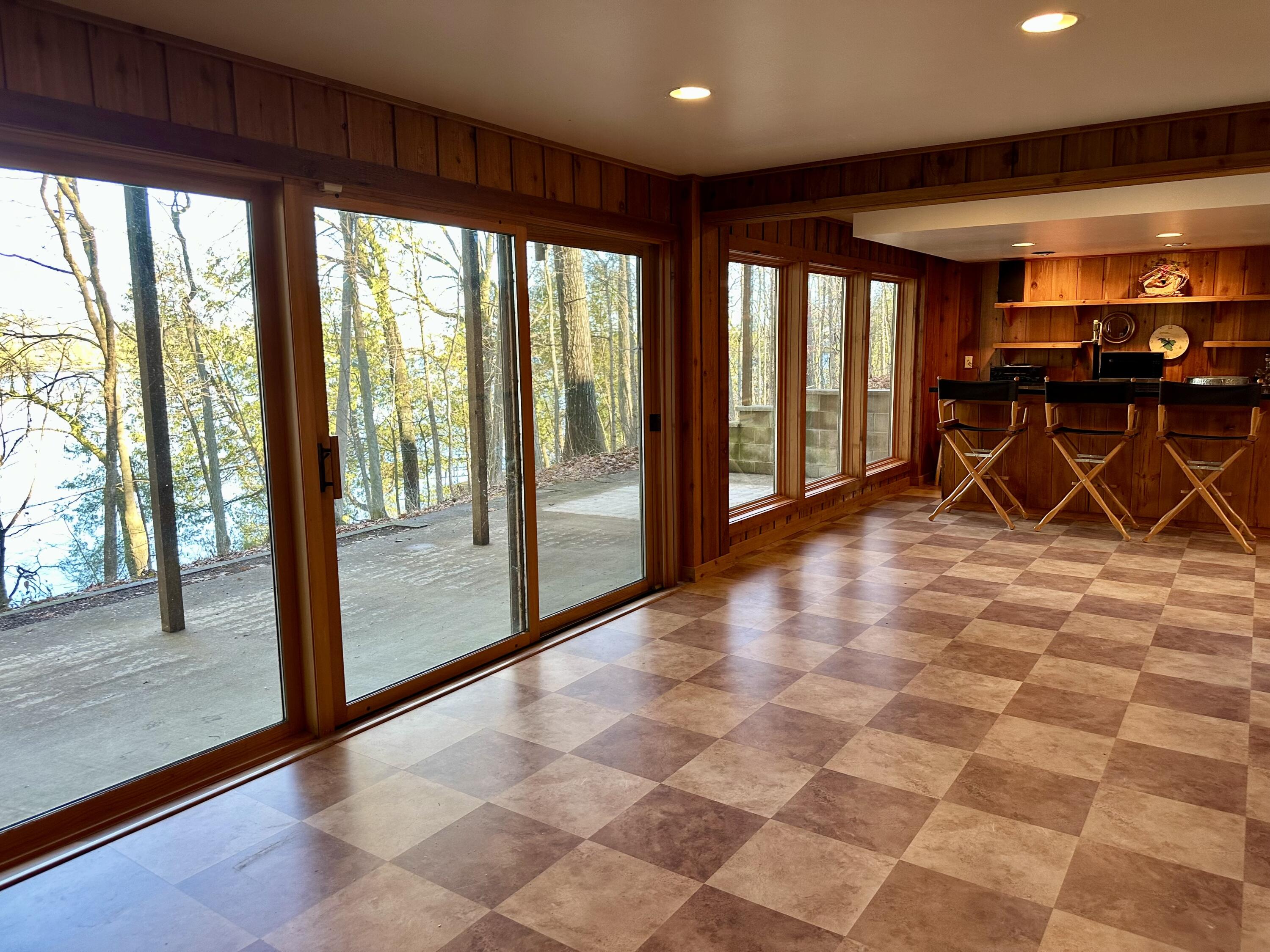 N7859 Lakeside Park Road Rhine, WI 53020 - Photo 35 of 79 Lower Level Bar Living Walkout to Patio Lake