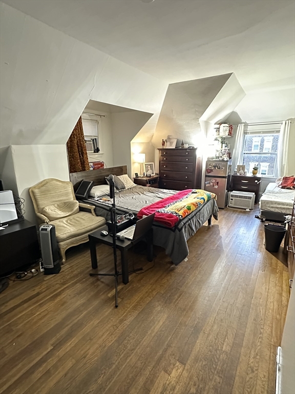 a bedroom with furniture and a wooden floor