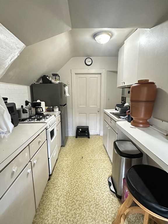 18 Quint Avenue, Unit 3 Boston, MA 02134 - Photo 11 of 11 a kitchen with sink cabinets and stove