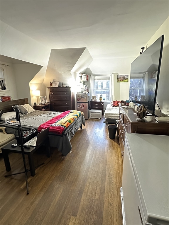 18 Quint Avenue, Unit 3 Boston, MA 02134 - Photo 2 of 11 a bedroom with furniture and a wooden floor