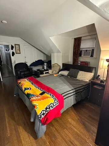 a living room with hard wood flooring and a couch