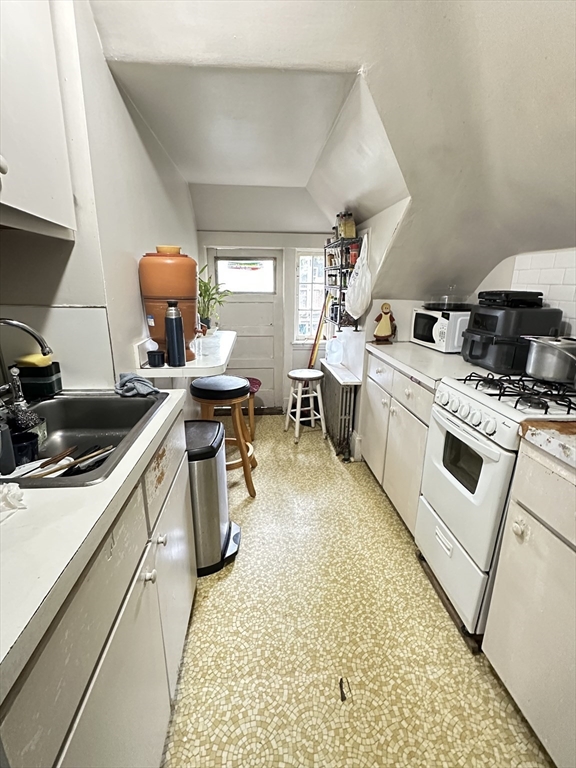 18 Quint Avenue, Unit 3 Boston, MA 02134 - Photo 5 of 11 a kitchen with a sink appliances and cabinets