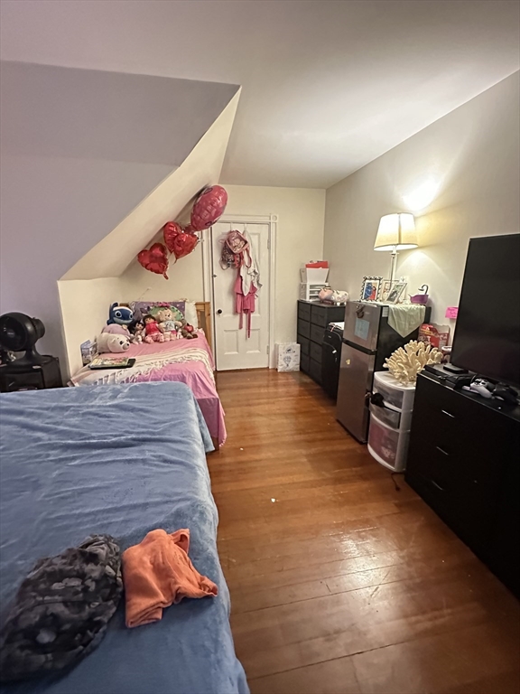 18 Quint Avenue, Unit 3 Boston, MA 02134 - Photo 7 of 11 a bedroom with furniture and a bed