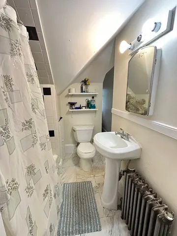 a bathroom with a sink toilet and mirror