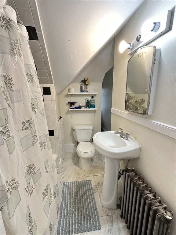 18 Quint Avenue, Unit 3 Boston, MA 02134 - Photo 8 of 11 a bathroom with a sink toilet and mirror