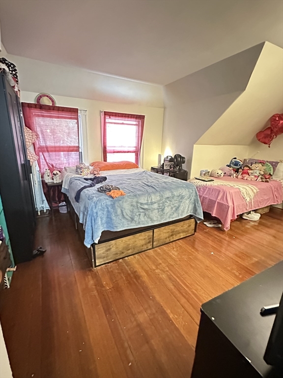 18 Quint Avenue, Unit 3 Boston, MA 02134 - Photo 10 of 11 a bedroom with a bed and window