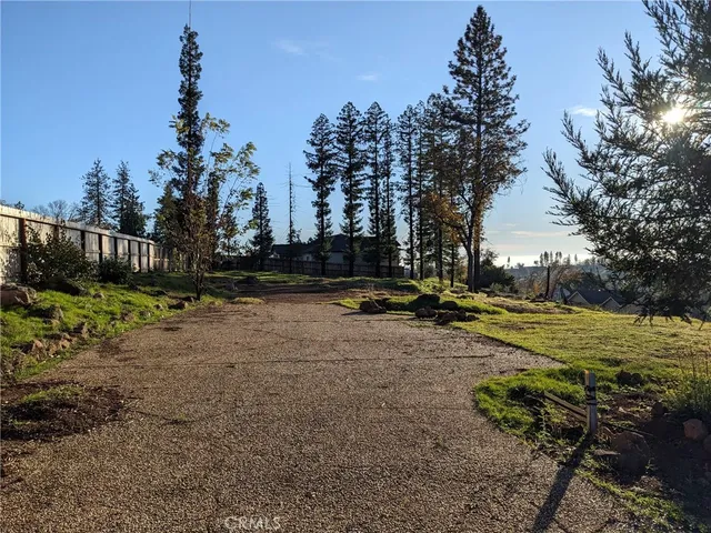 a view of a yard with wooden fence
