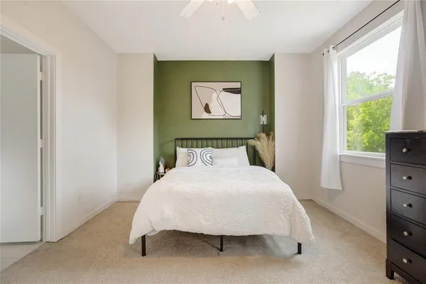 a bedroom with a bed and a dresser
