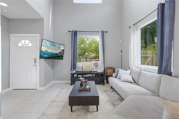 a living room with furniture and a large window
