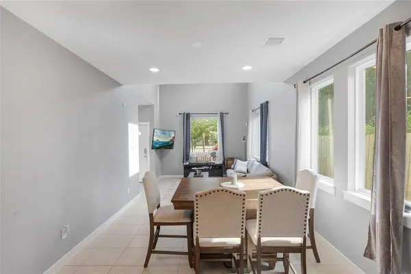 a dining room with furniture and window
