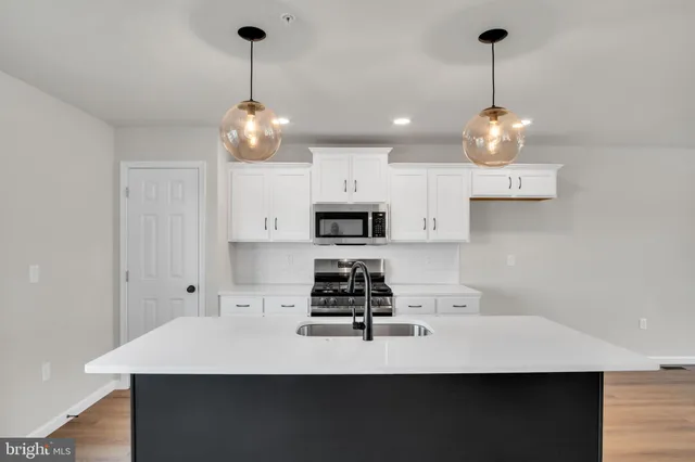 a kitchen with a sink a stove and kitchen island