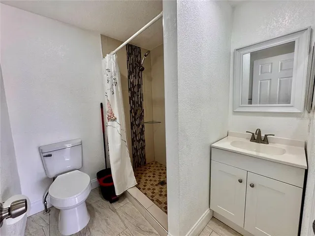 a bathroom with a toilet sink and shower