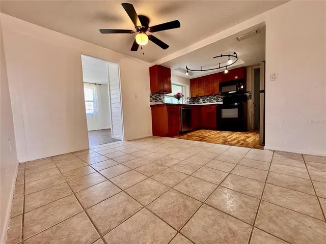 a view of a livingroom with a ceiling fan and window
