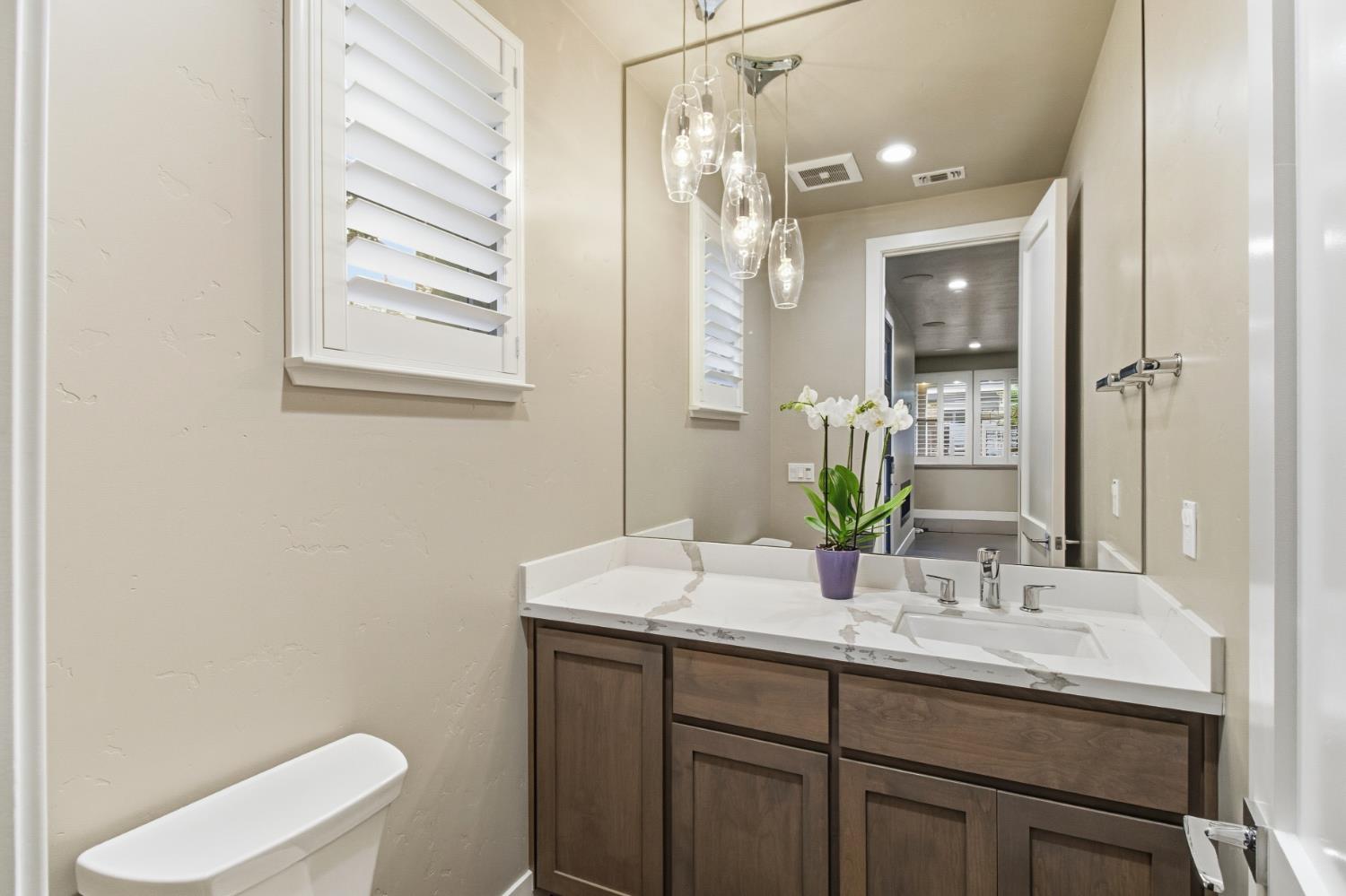 309 Fairgate Road Sacramento, CA 95825 - Photo 17 of 48 a bathroom with a granite countertop sink a toilet and a mirror