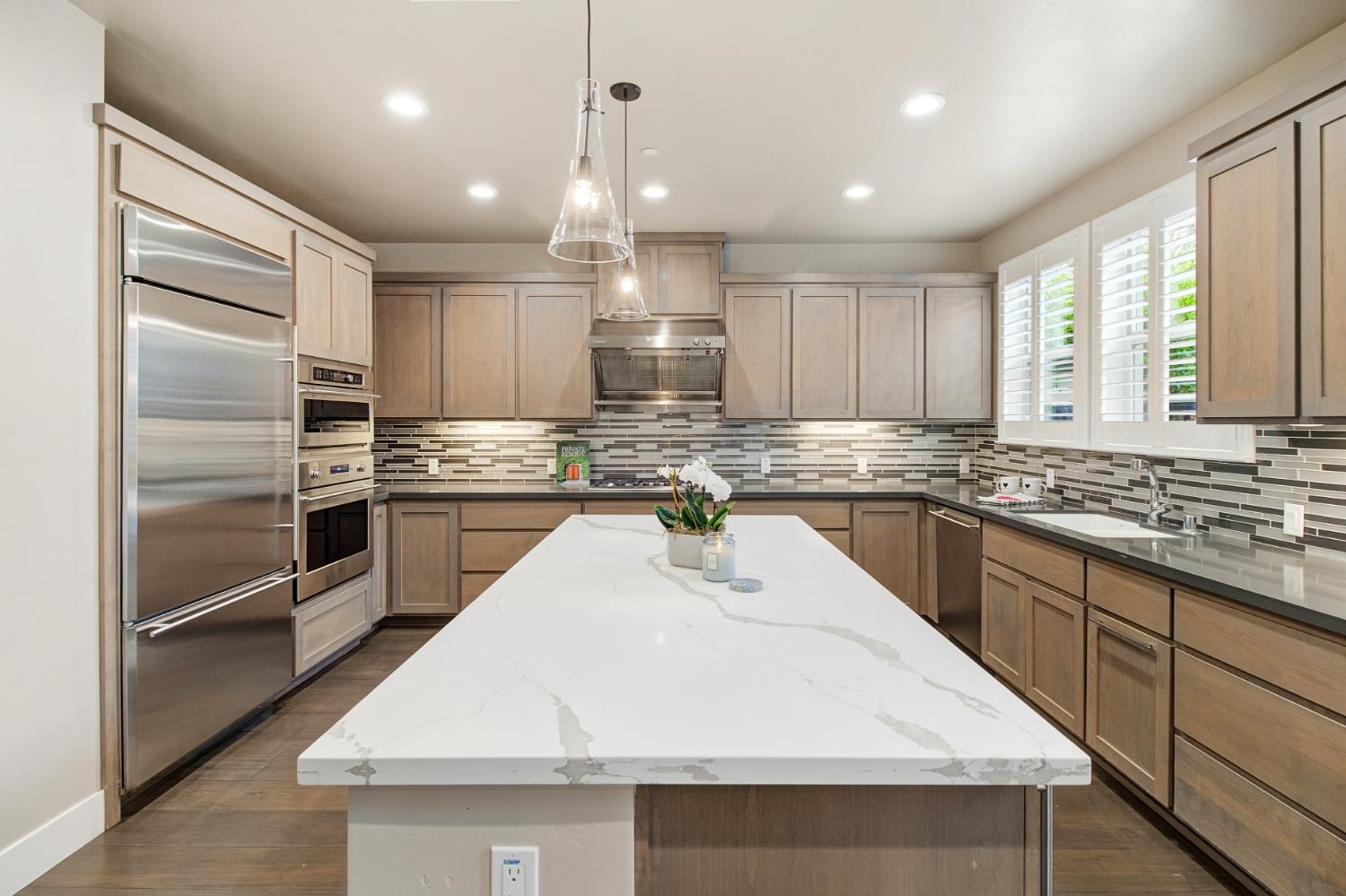 309 Fairgate Road Sacramento, CA 95825 - Photo 8 of 48 a kitchen with kitchen island granite countertop a sink a counter space stainless steel appliances and cabinets